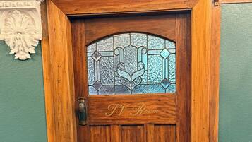 A wooden door with a glass panel and the inscription "TV Room".