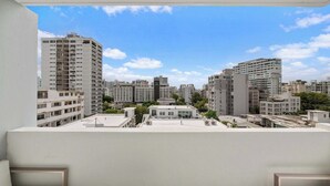 A high-rise building with multiple floors and balconies, surrounded by other buildings. - Sun Drift Views | Modern in the Heart of Condado (San Juan)