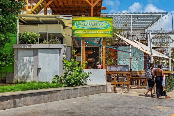 A restaurant named Kabanas with a signboard advertising tacos, burgers, and drinks.