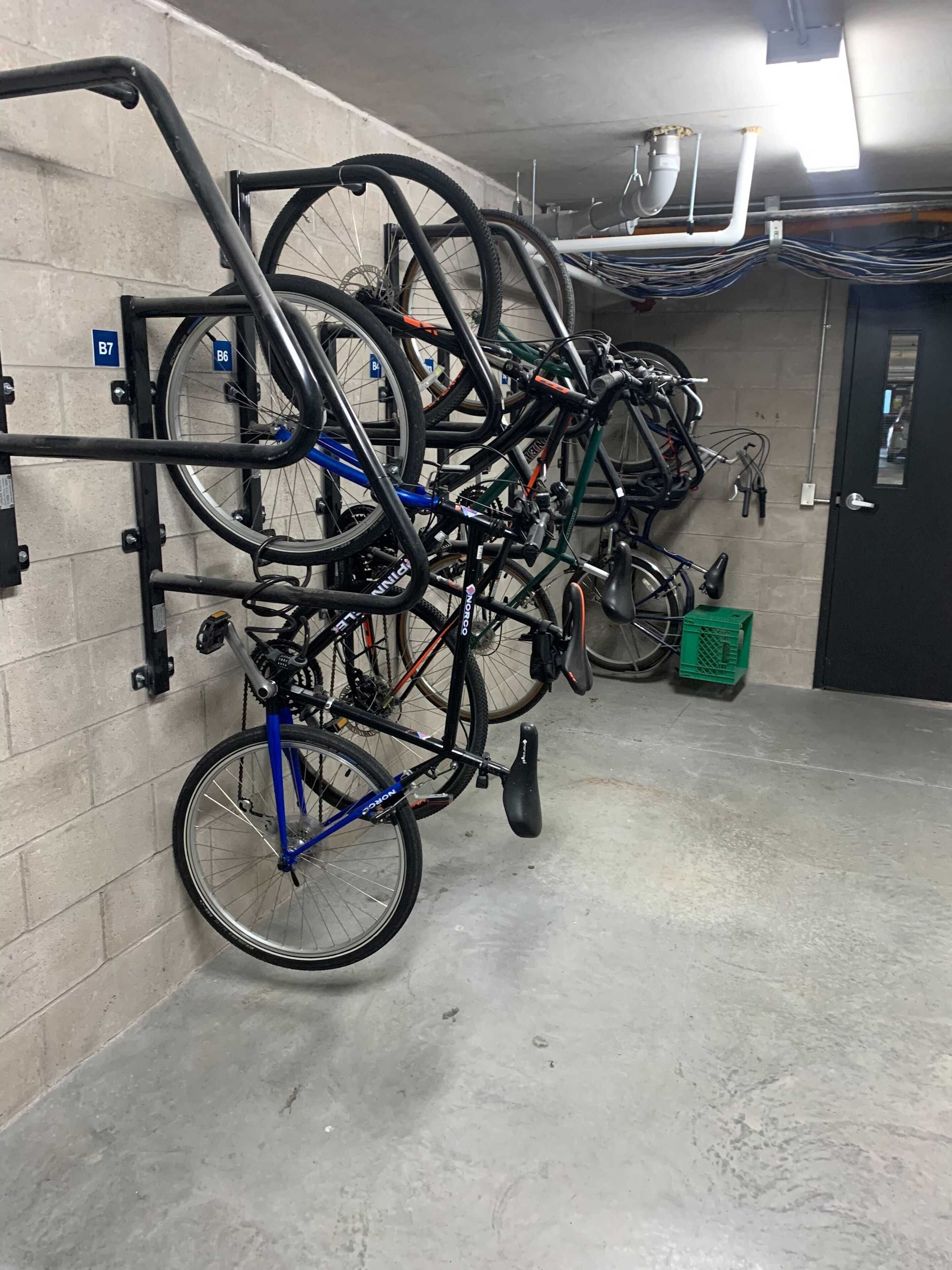 A bike parking area with multiple bicycles secured to a rack.