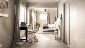 A compact bedroom with a bed, a desk with a laptop, a chair, and a ceiling fan. - Pool & Palmz|Hot Tub|Fire Pit|Chefs Kitchen|6 beds (San Diego)