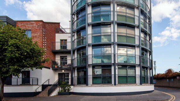 A multi-story building with a curved facade, featuring balconies with metal railings. - Stylish and trendy 2bed apartment in city centre. (Dublin)