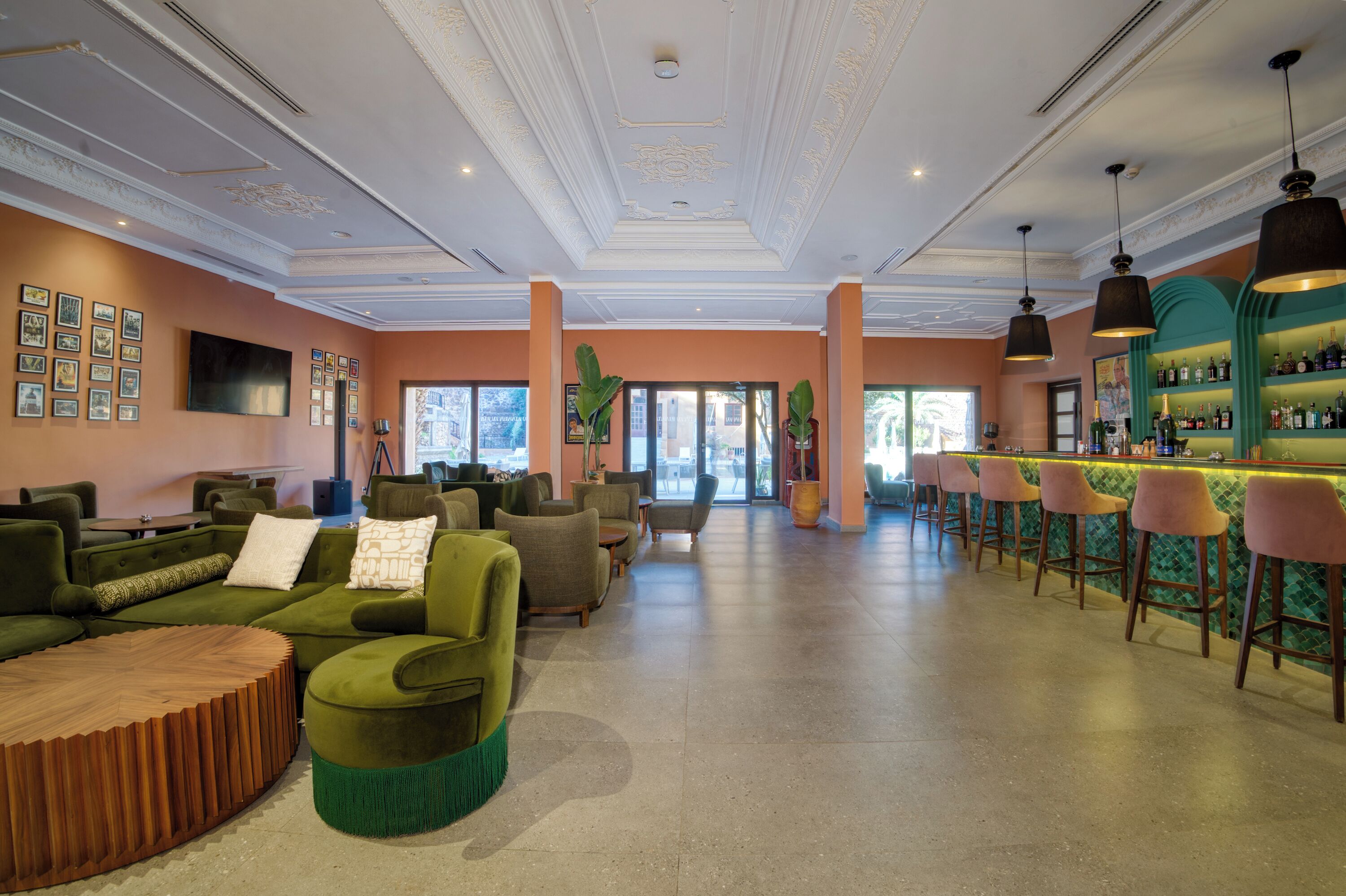 A spacious lobby with a bar area, seating arrangements, and a large window providing natural light.