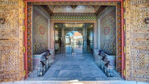 An ornate entrance with intricate tile work, a glass door, and a marble floor. - AMANAR Ouarzazate Boutique Hôtel & SPA  (Ouarzazate)