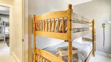 A bunk bed with a wooden frame and a headboard with vertical slats.