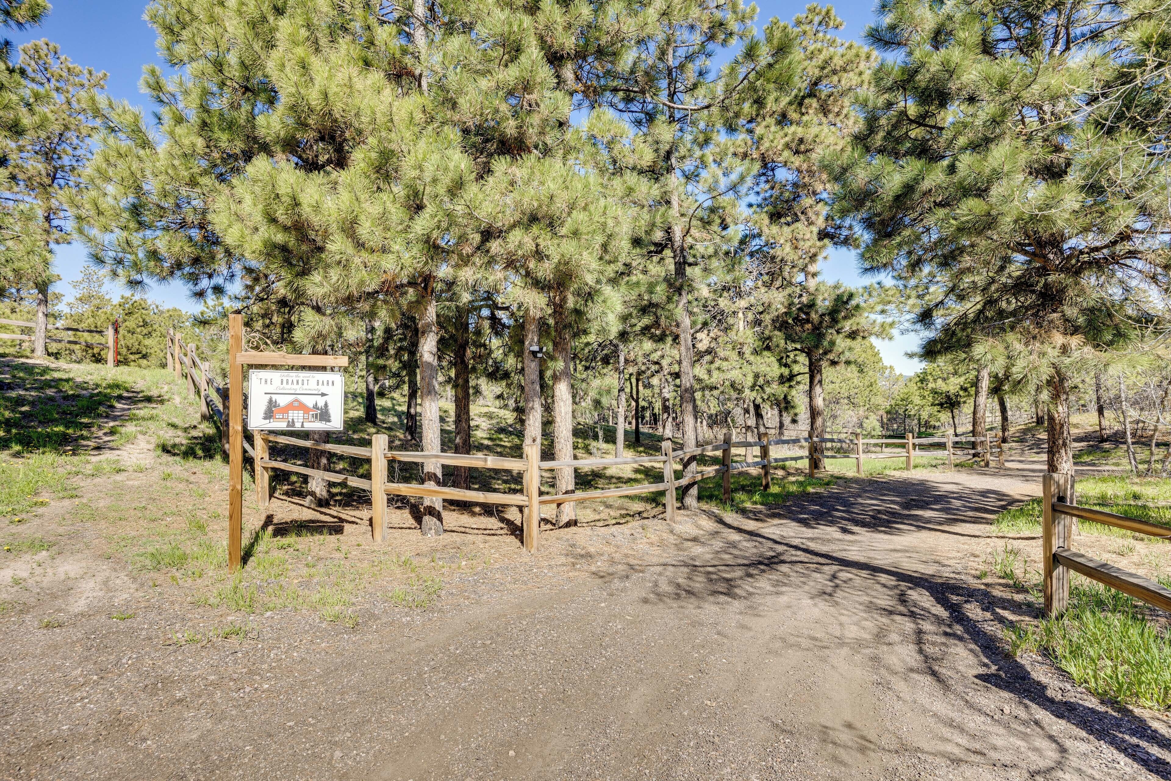 A wooden fence with a sign indicating The Brantot Barn.