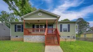 A two-story house with a front porch and a staircase leading to the entrance. - Commuter-friendly Home: 3 Mi to Dtwn Knoxville! (Knoxville)