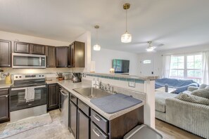 A modern kitchen with dark cabinetry, stainless steel appliances, and a granite countertop. - Commuter-friendly Home: 3 Mi to Dtwn Knoxville! (Knoxville)