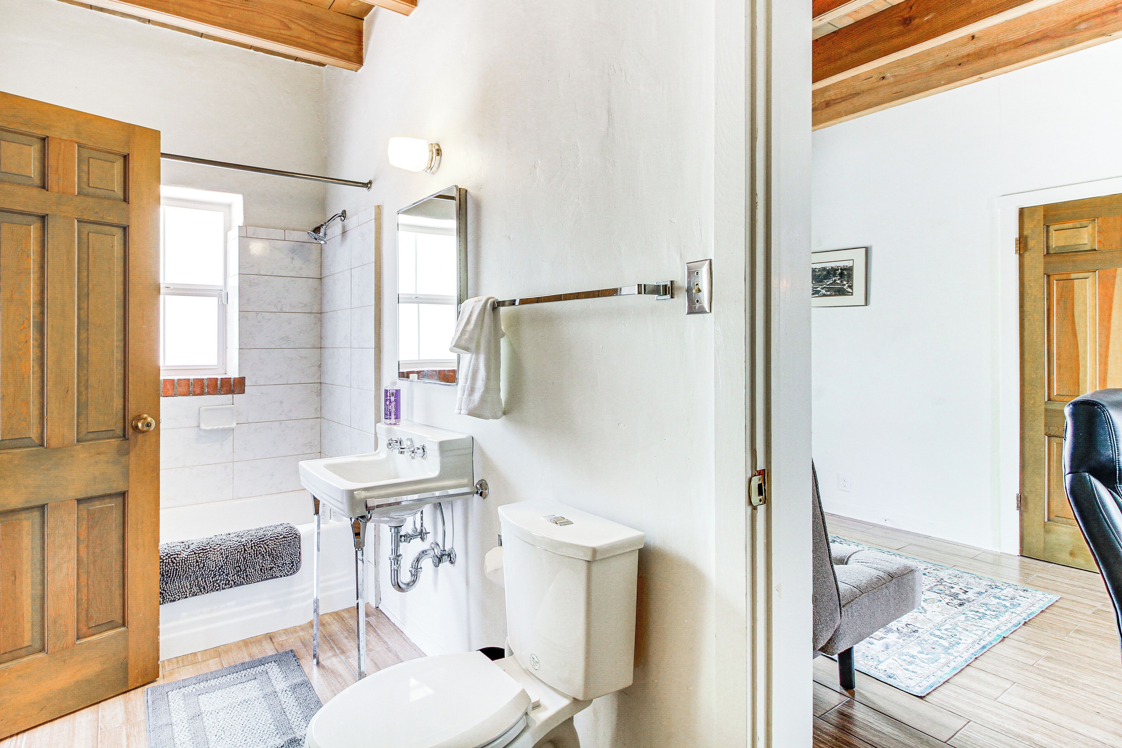 A bathroom with a toilet, sink, and shower area.