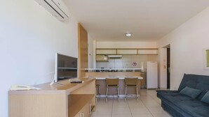A modern apartment with a kitchen, dining area, and living room.