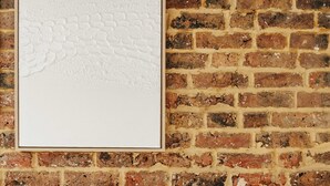 A framed artwork on a brick wall. - The Primrose Mews in Greater London (London)