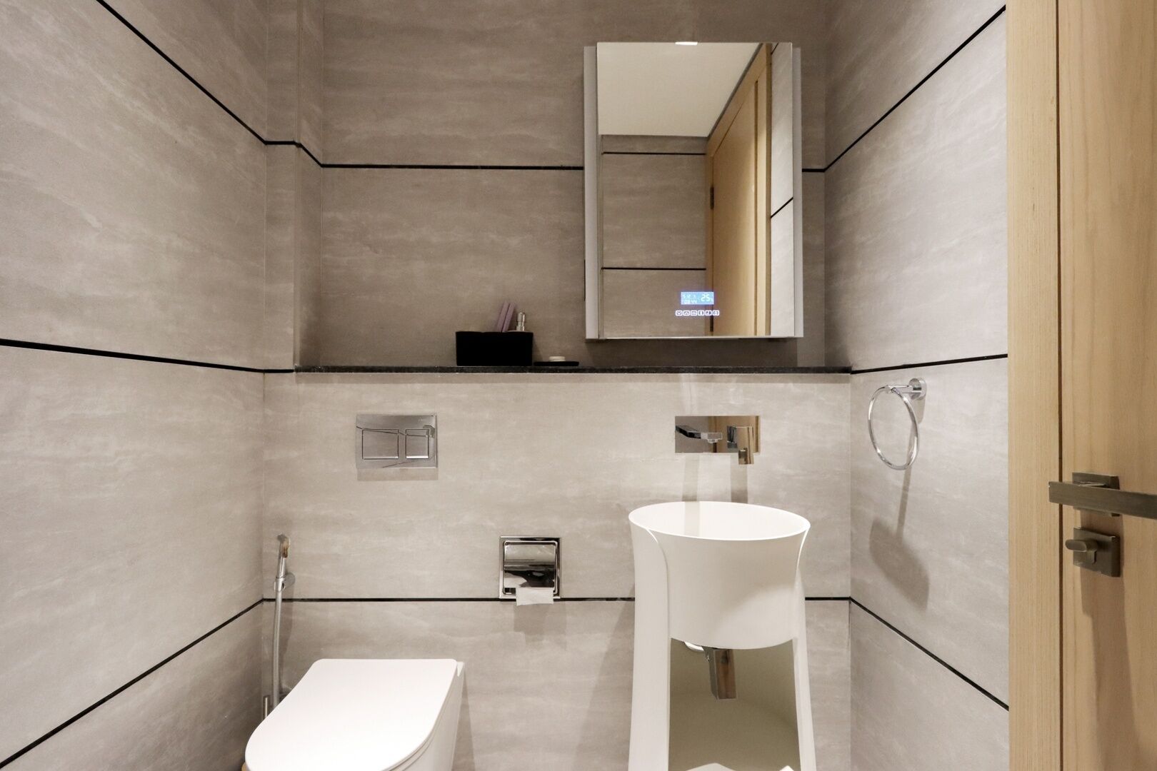 A modern bathroom with a toilet, sink, and shower.