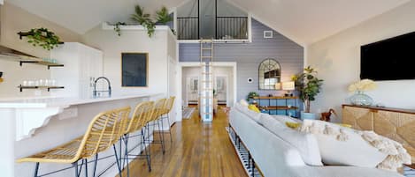A modern interior with a kitchen, bar area, and seating.