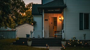 A house with a porch, steps, and a 'Welcome Friends' sign. - Magnolia Manor - Remodeled Home Near Downtown (Lake Geneva)