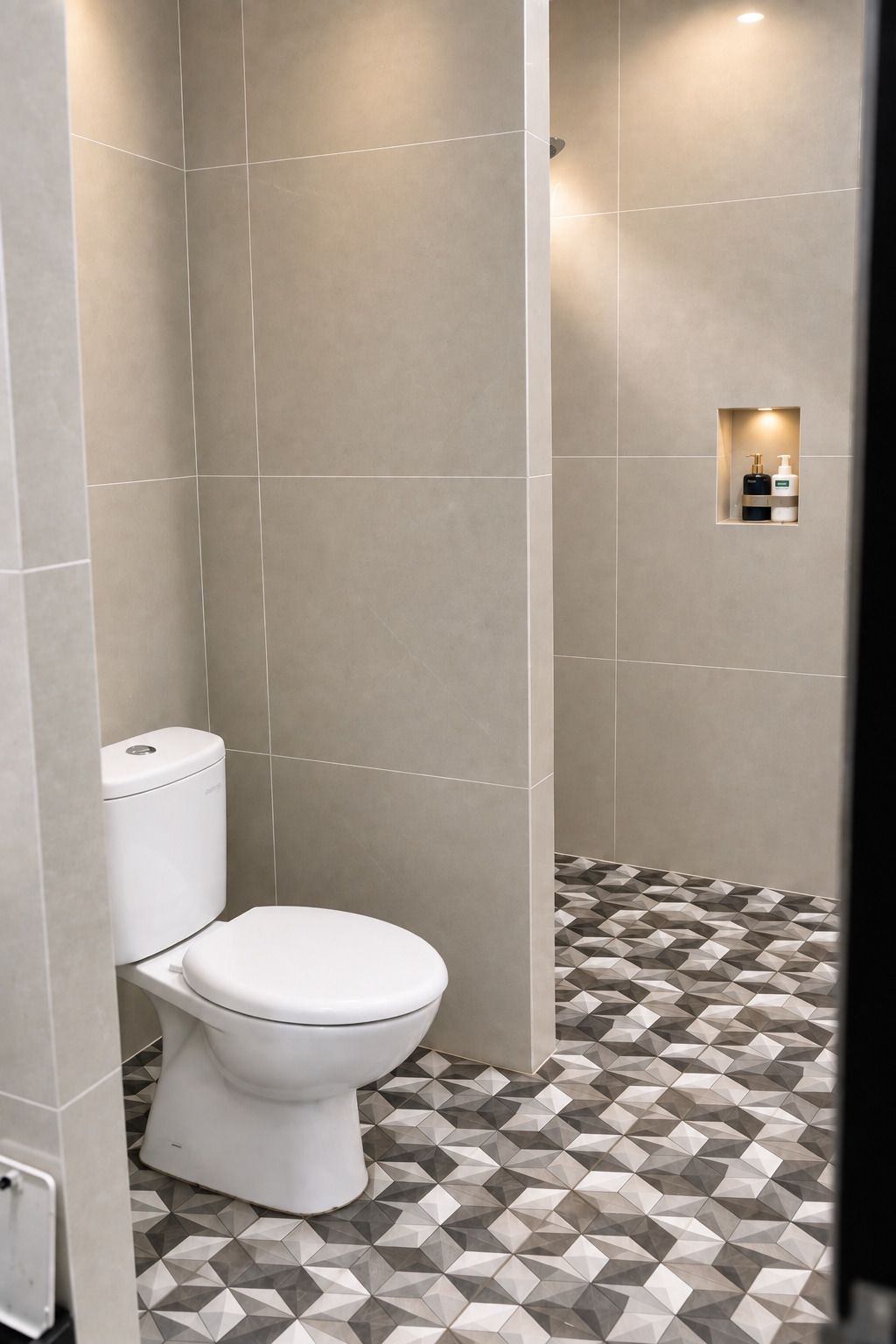 A bathroom with a toilet, a geometric patterned floor, and a small shelf with toiletries.