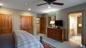 A bedroom with a bed, wooden wardrobe, a television, and a ceiling fan. - Trail's End Lodge at Deer Valley Resort - Two Bedroom Residence with Spa #101 2 Condo (Park City)