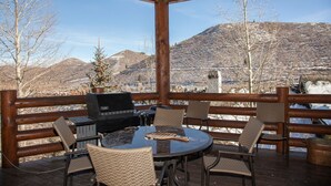 A covered outdoor area with a grill, wicker chairs, and a table. - Trail's End Lodge at Deer Valley Resort - Two Bedroom Residence with Spa #406 2 Condo (Park City)