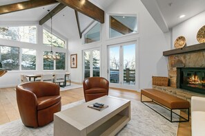 A spacious living room with leather armchairs, a coffee table, and a stone fireplace. - Trail's End Lodge at Deer Valley Resort - One Bedroom Deluxe Residence with Spa #304 1 Condo (Park City)