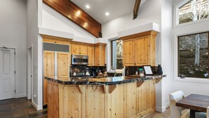 A spacious kitchen with wooden cabinets, a granite countertop, and a built-in microwave. - Trail's End Lodge at Deer Valley Resort - One Bedroom Deluxe Residence with Spa #304 1 Condo (Park City)