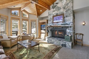 A cozy living room with a stone fireplace, leather furniture, and large windows. - Trail's End Lodge at Deer Valley Resort - Four Bedroom Residence with Spa #18 4 Condo (Park City)