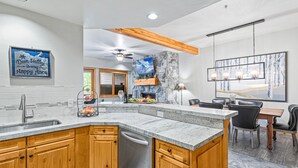 A modern kitchen with granite countertops, wooden cabinets, and a built-in dishwasher. - Trail's End Lodge at Deer Valley Resort - Two Bedroom Residence with Spa #404 2 Condo (Park City)