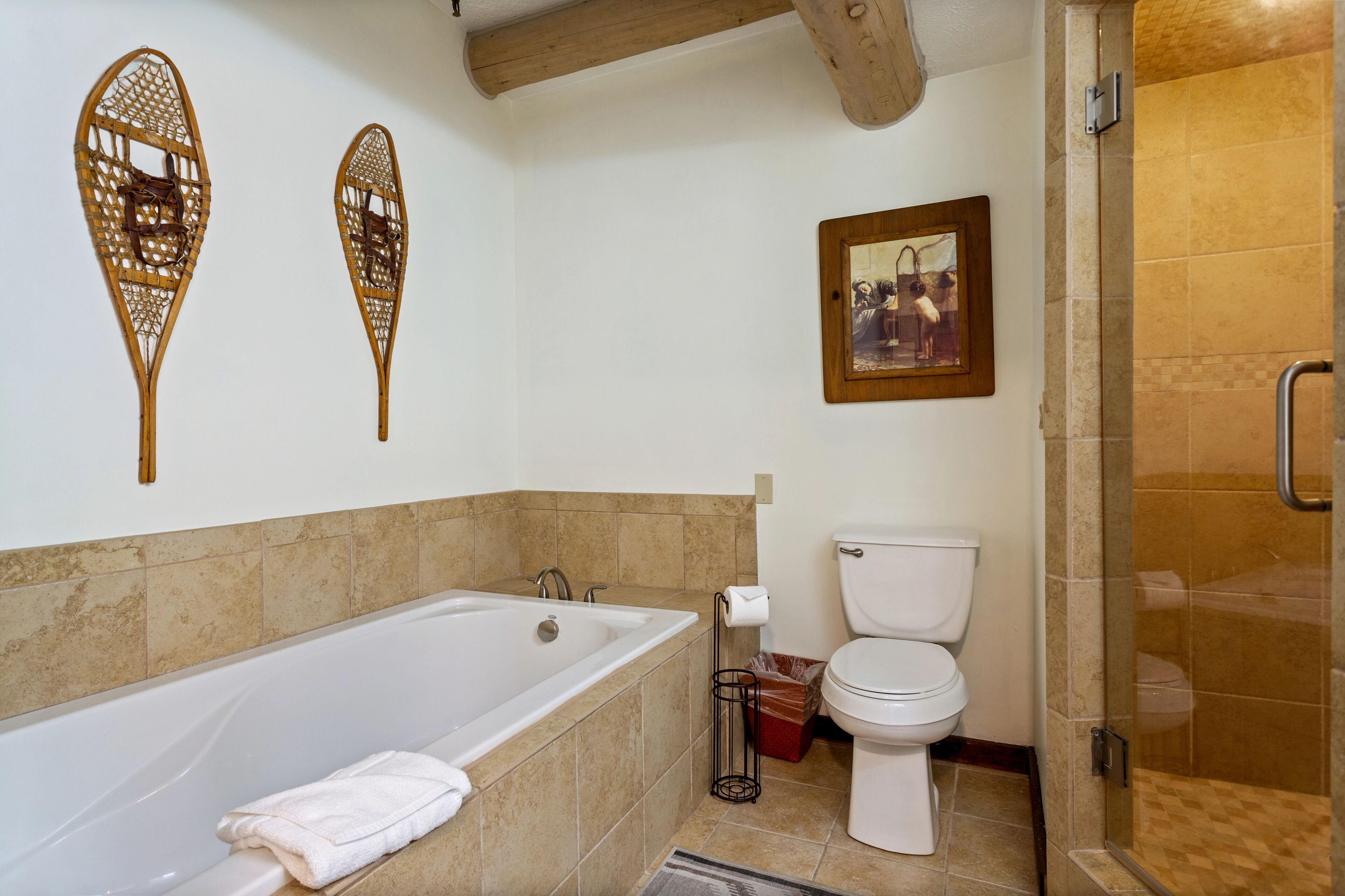A bathroom with a bathtub, toilet, and shower.