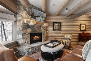 A log cabin interior with a stone fireplace, wooden beams, and a cozy seating area. - Pine Inn 9 - Two Bedroom Condo with Spa Trail's End Lodge by Deer Valley Resort (Park City)
