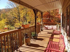 A wooden deck with a railing, a bench, and a potted plant. - CR-304  Moose Manor, 5 BR 4 Full Baths Game Room (Beech Mountain)