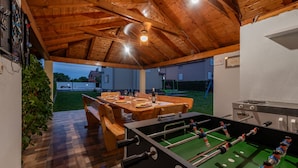 An indoor recreational area with a foosball table, a dining table set for four, and a dartboard. - Villa Sami Zadar Villas (Benkovac)