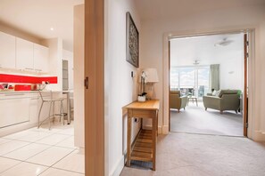A modern apartment with a kitchen, a dining area, and a living room.