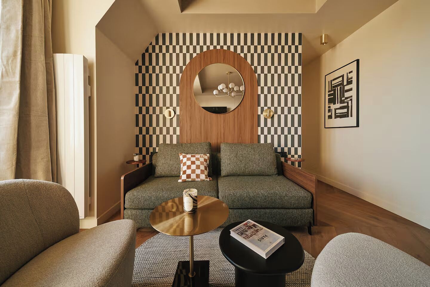 A modern living room with a sofa, two side tables, a coffee table, and a checkered throw pillow.