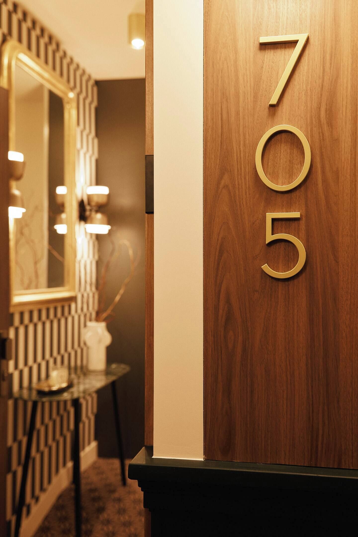 A wooden door with the numbers "705" indicating a room number.