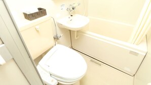 Une salle de bain avec des toilettes, un lavabo et une baignoire.