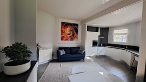 A modern kitchen with white cabinets, a black countertop, and a window. - Apartment MXP Milan Como Laghi free private parking (Castellanza)
