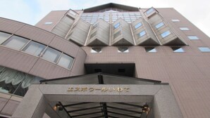 A building with a modern architectural design, featuring a prominent entrance with a sign in a foreign language. - Espoir Iwate (Morioka)