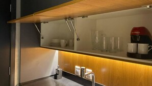 A modern kitchen with a wooden countertop, a built-in shelf, and a coffee machine. - OSCAR FREIRE 614 (Pinheiros São Paulo)