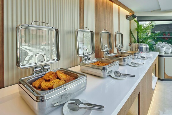 A buffet setup with various food containers and utensils. - Çırağan Hotel Bosphorus (Istanbul)