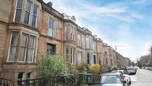 A row of terraced houses with a narrow street in between.