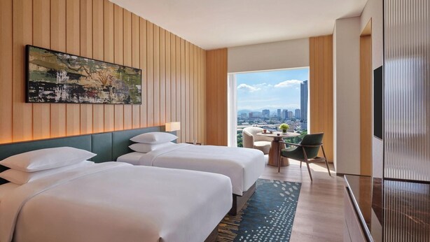 A hotel room with two beds, a city view, a dining area, and a TV. - Hyatt Regency Kuala Lumpur At Kl Midtown (Kuala Lumpur)