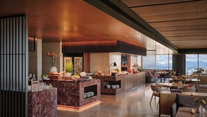 A modern hotel lobby with a marble reception desk, a buffet area, and seating arrangements. - Hyatt Regency Kuala Lumpur At Kl Midtown (Kuala Lumpur)