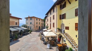A cobblestone street with outdoor seating and a café.