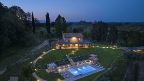A large house with a swimming pool, outdoor seating, and a well-maintained lawn. - Agriresort Bacaringhe 13, Emma Villas (Terricciola)
