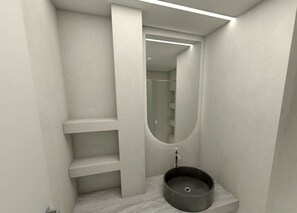 Casa de banho moderna com lavatório embutido, espelho e escadaria para um andar superior.