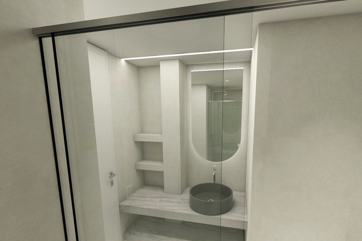 A modern bathroom with a glass-enclosed shower, a round sink, and built-in shelves.