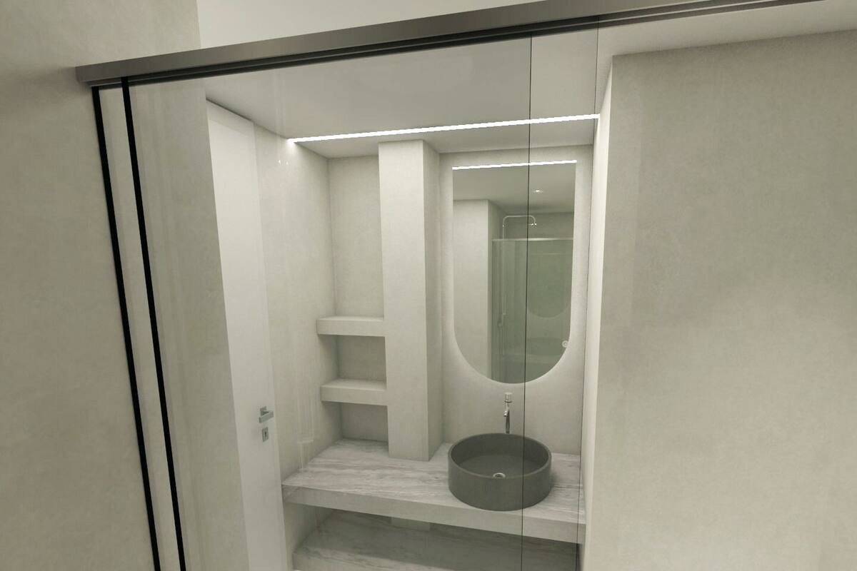 Un baño moderno con ducha envuelta en vidrio, un lavabo redondo y estantes empotrados.