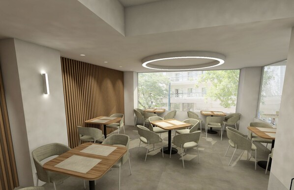 A modern indoor seating area with tables and chairs, large windows, and a circular light fixture. - Zein Boutique Athens Hotel (Athens)