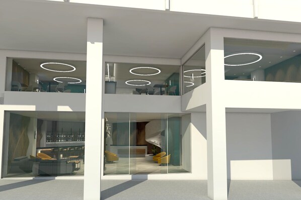 Un edificio moderno de varios niveles con paredes de vidrio, un comedor y un espacio de estar con sofá y sillones.