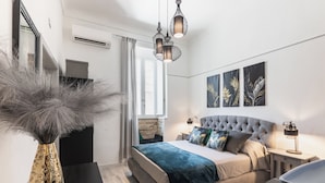 A modern bedroom with a bed, bedside tables, a vase, and artwork on the wall. - Maison Beata - Two Bedroom Apartment, Sleeps 5 (Avola)