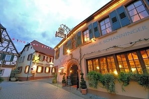 A building with a sign reading 'FAMILIE SCHANNINGER' and a traditional European architectural style.