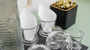 A collection of clear glass items, including a pitcher, glasses, and a small container, on a table. - GuestReady - Zenith Building - Room 001 (Porto)